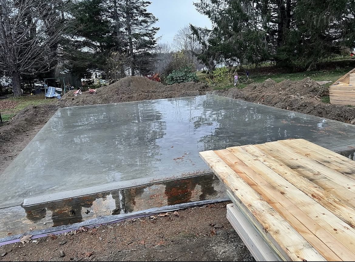 Finished concrete slab poured for a new attached garage in coastal Maine