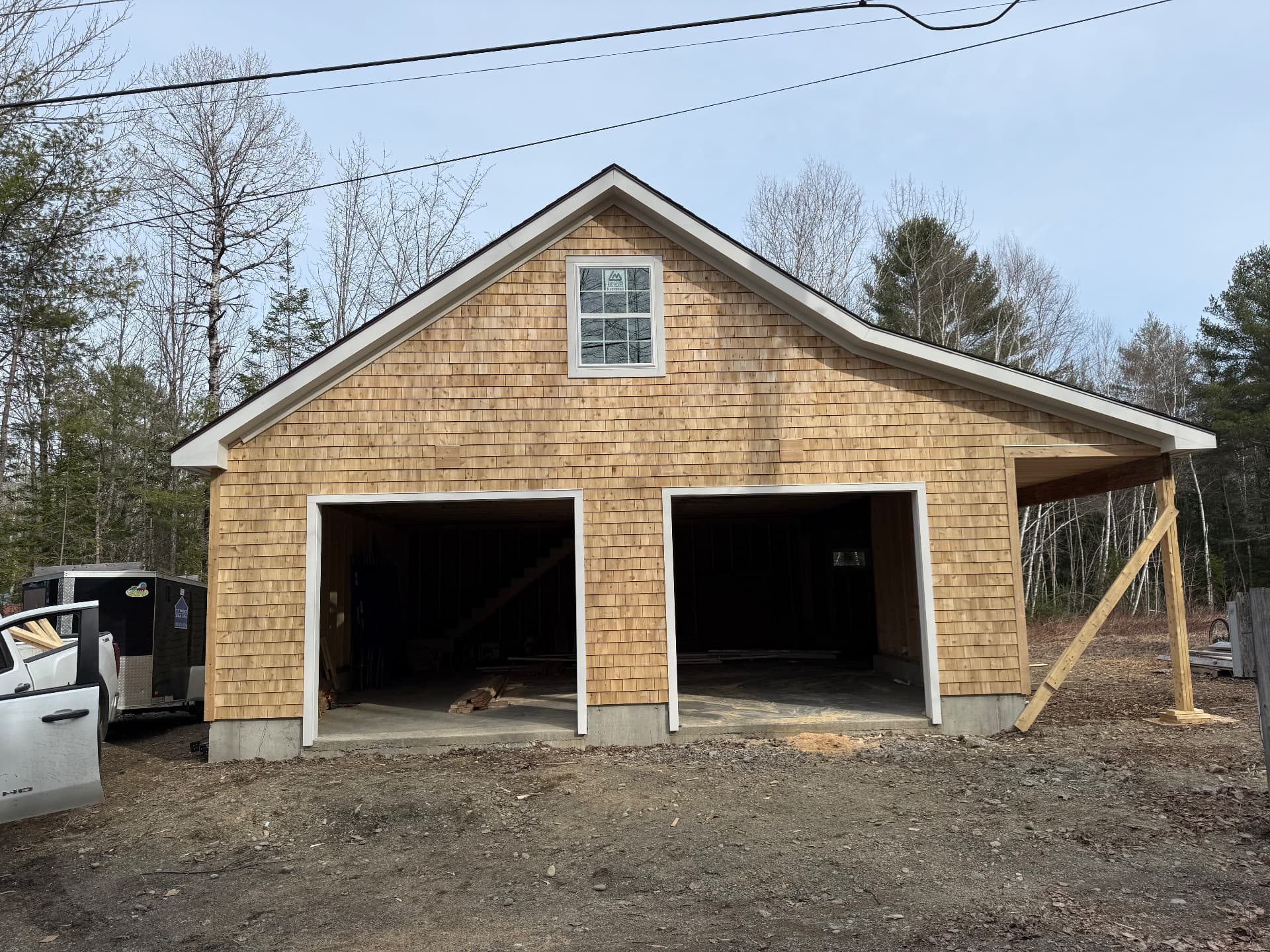 Finished cedar shingle two-bay detached garage with white trim