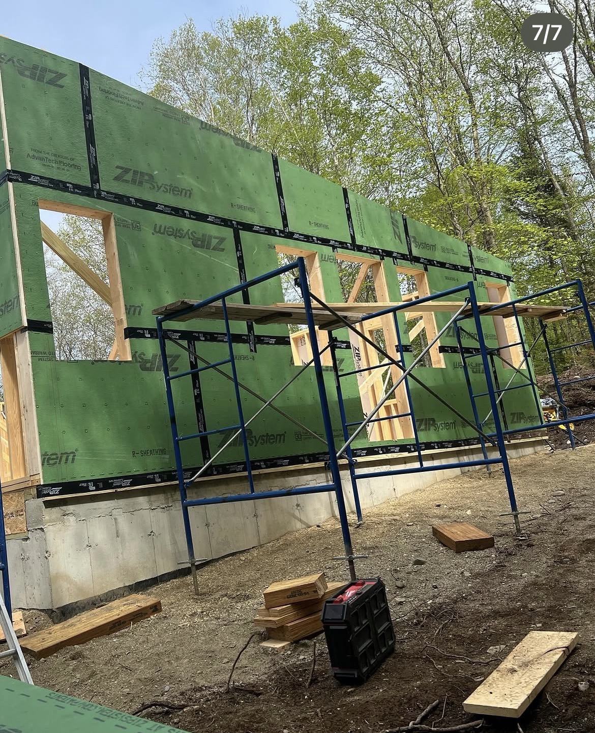 Tall ZIP System sheathed gable wall with scaffolding at the new coastal home