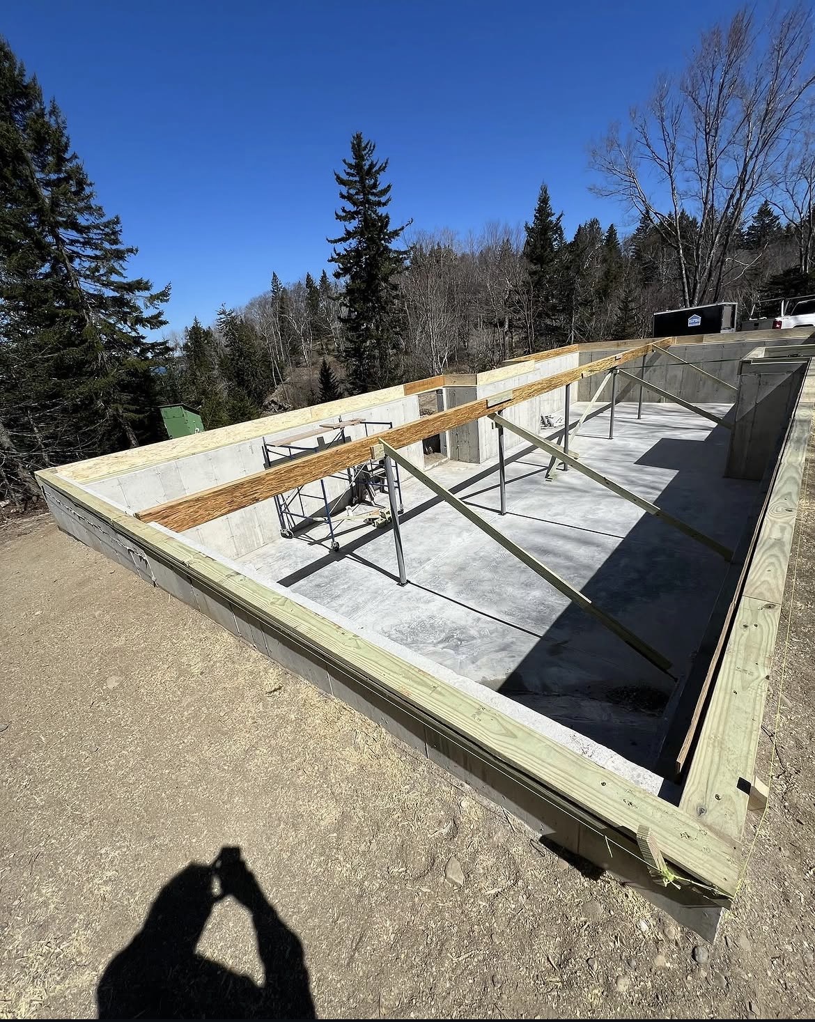 Poured concrete foundation with sill plates set for a new waterfront home in Maine