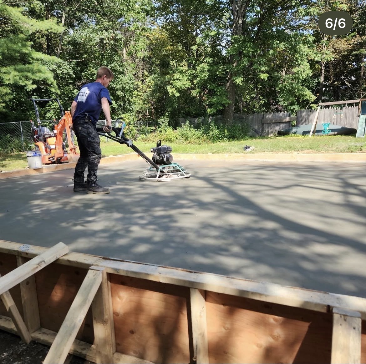 Power troweling a new concrete slab to a smooth finish
