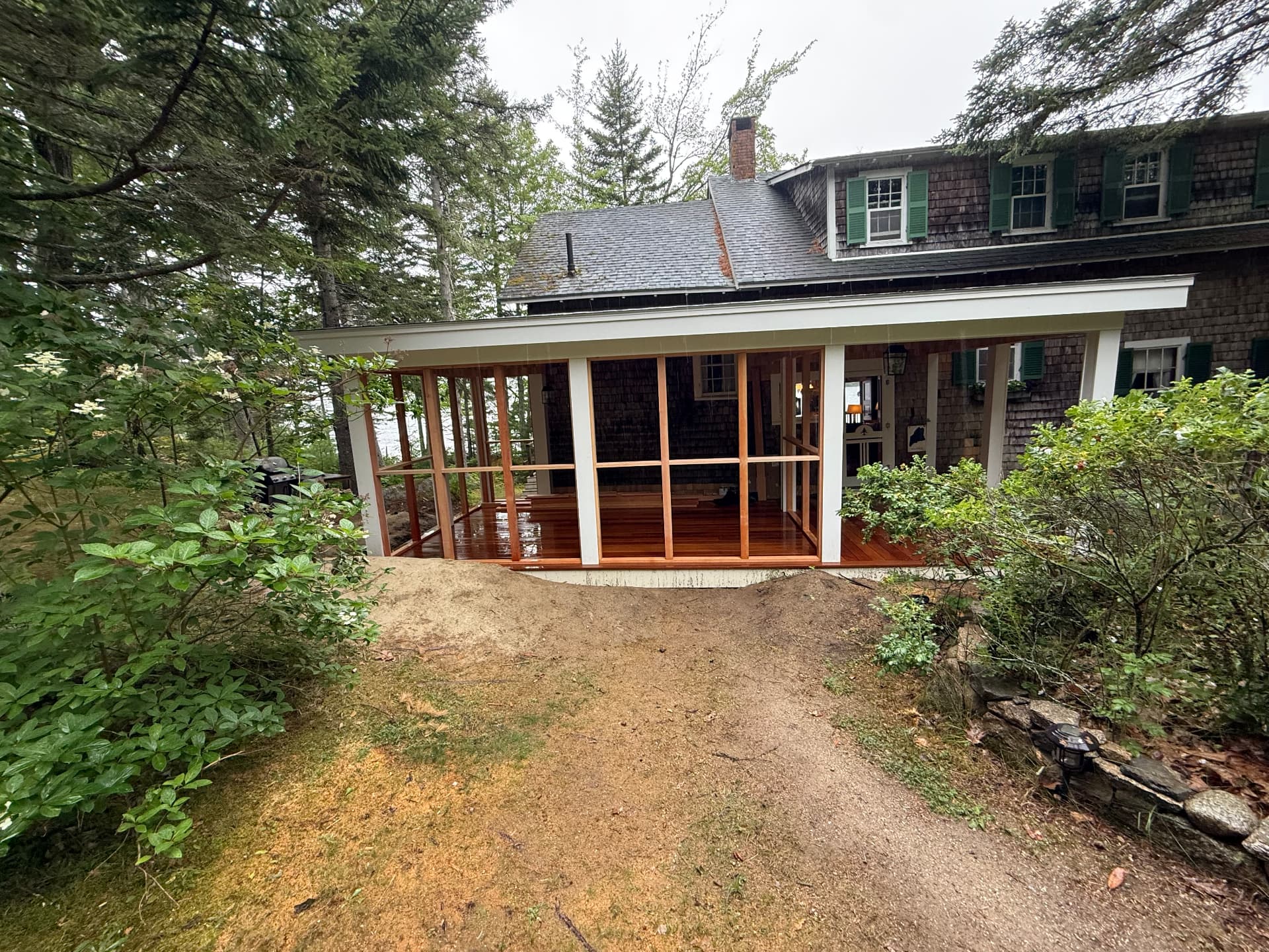 Completed screened porch addition overlooking the water in Maine
