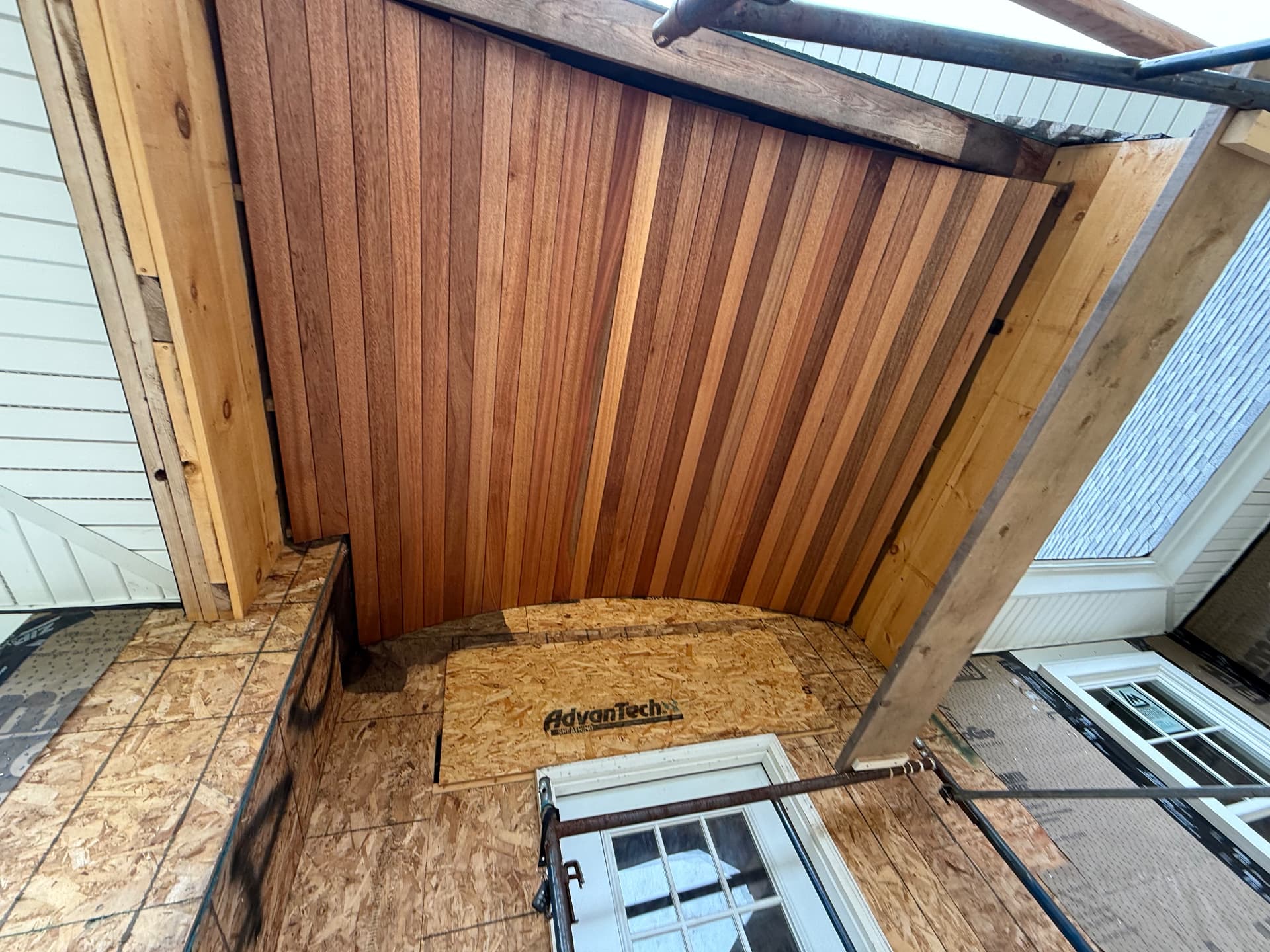 Mahogany tongue-and-groove porch ceiling installed under a new porch roof