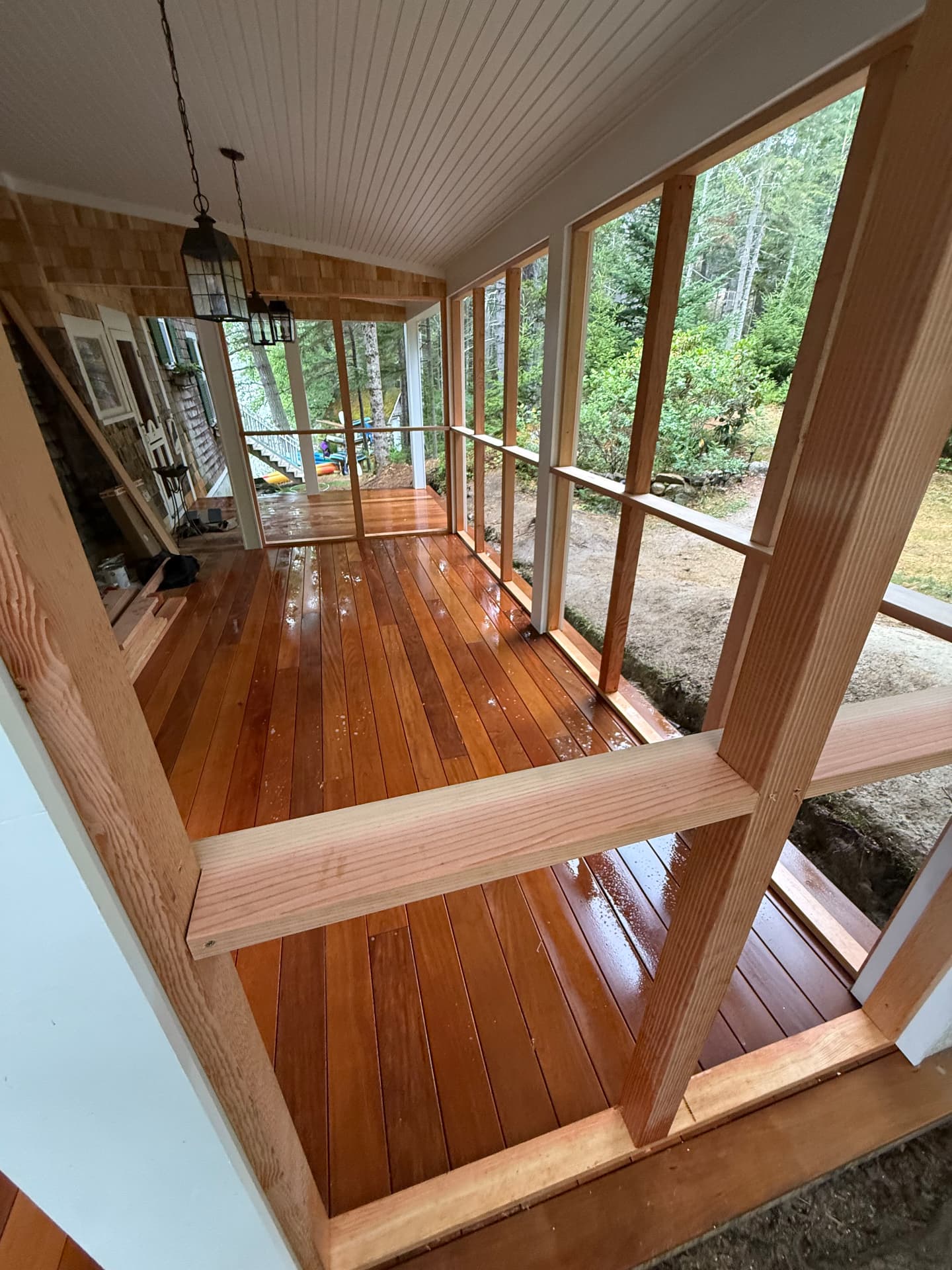 Finished mahogany porch decking and screens inside a new screened porch