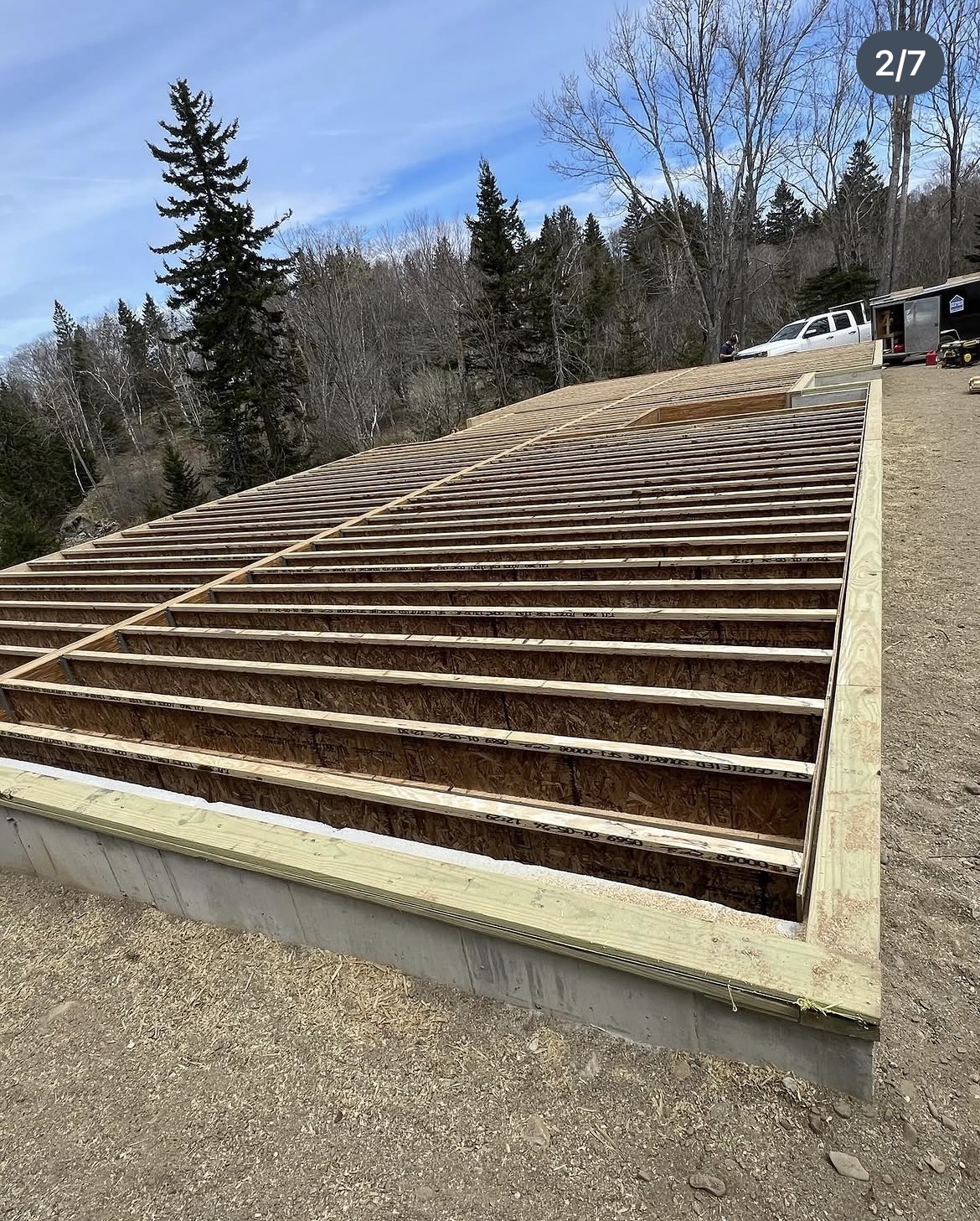 Floor joists framed across the foundation of a new coastal Maine home