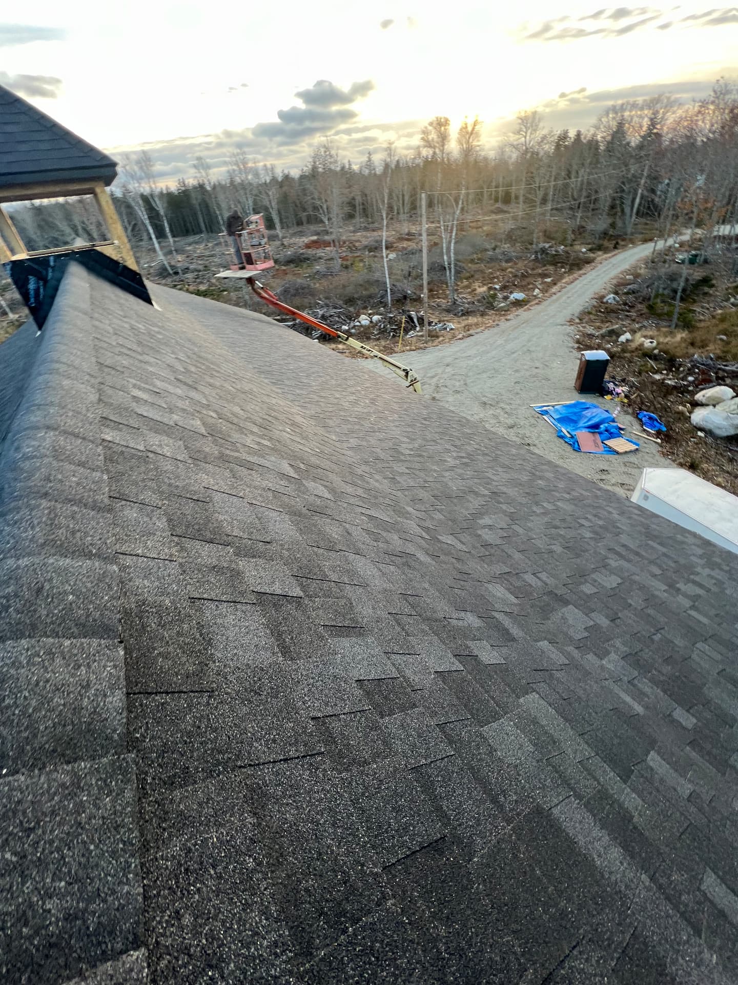 Newly shingled roof at sunset on a coastal Maine new build