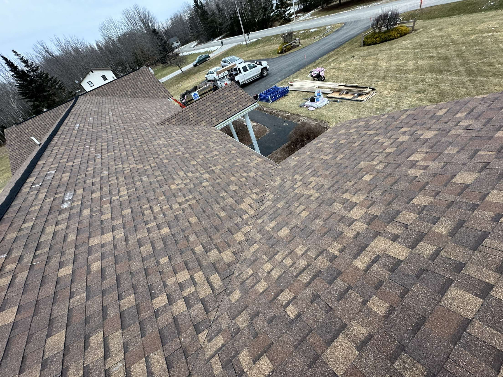 Completed architectural shingle roof spanning the house and attached garage