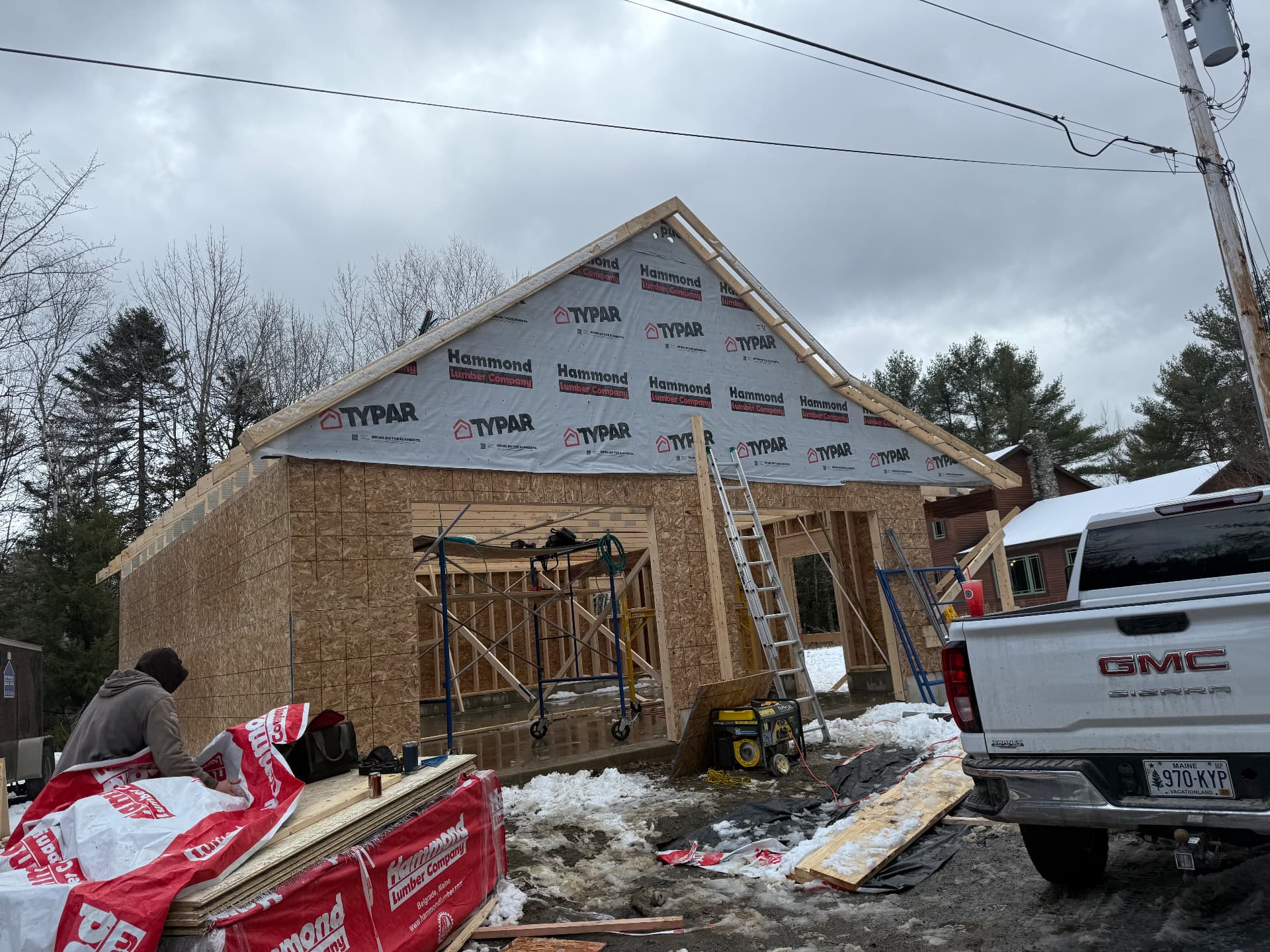Two-bay garage framed and wrapped with Typar house wrap in Maine