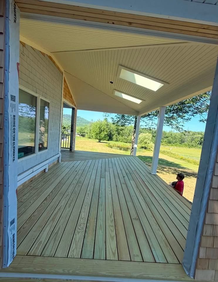 Covered porch with pressure-treated decking overlooking the Maine countryside